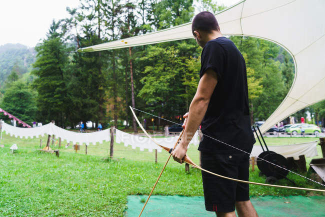 Man practicing archery in school — Stock Photo