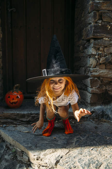 Girl in halloween costume looking at camera — Stock Photo