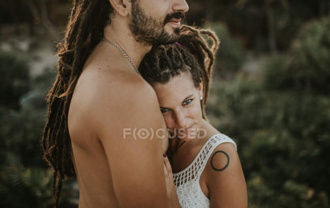 Crop image of sensual couple embracing on background of tropical forest — Stock Photo