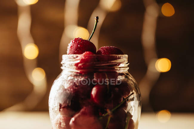 Glass jar with cherry — Stock Photo