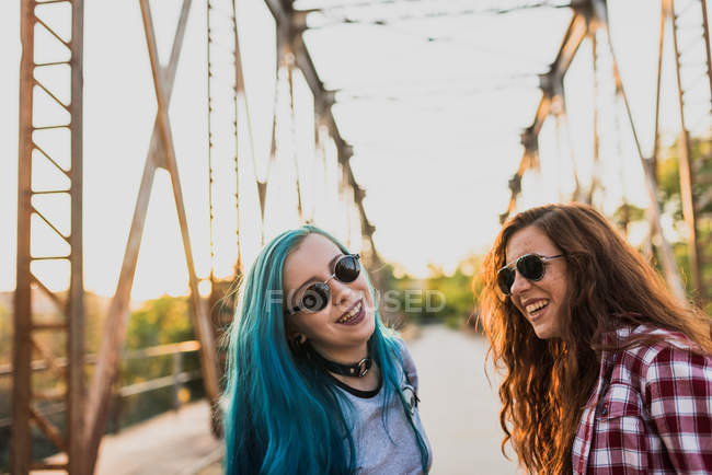 Punk teen girls laughing on a bridge. — Stock Photo