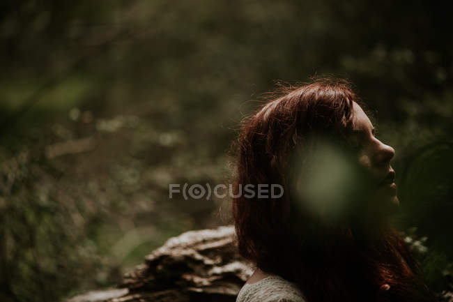 Portrait of ginger girl resting at forest — Stock Photo