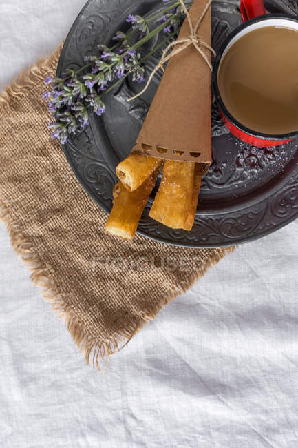 Plate with churros and lavender latte — Stock Photo