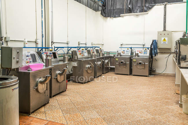Industrial laundry machines in line at clothing manufactures — Stock Photo