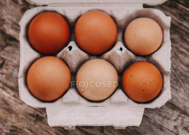Eggs on wooden table — Stock Photo