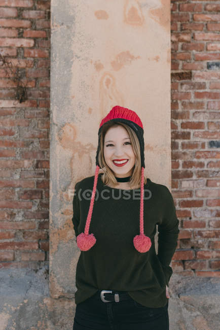 Irl in knitted hat smiling at camera — Stock Photo