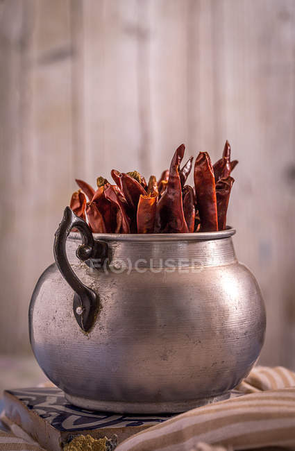 Spicy red chili peppers in pot — Stock Photo