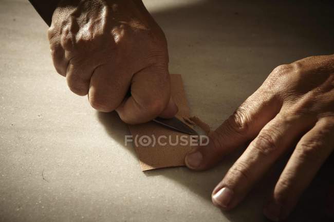 Artisan working with leather and tools — Stock Photo