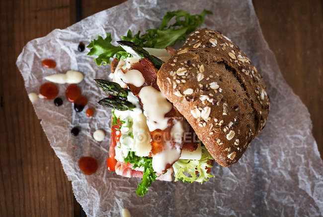 From above delicious sandwich with Parmesan on paper — Stock Photo