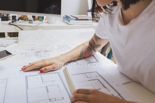 An unrecognizable female architect sitting and working on a project. — Stock Photo