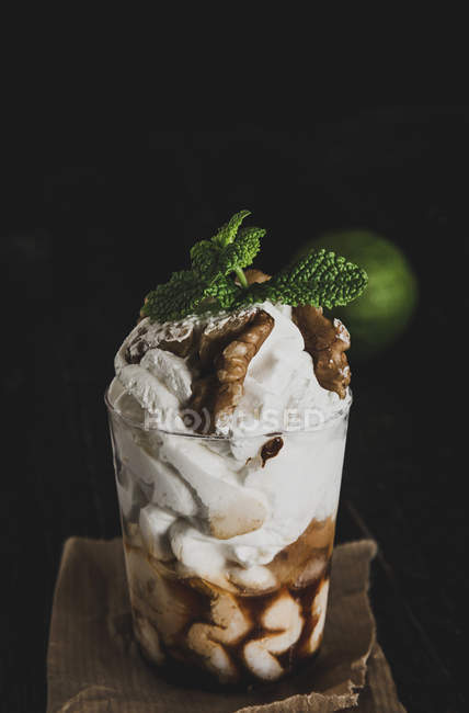 Glass of sundae decorated with nuts — Stock Photo
