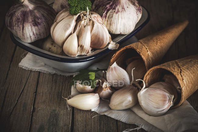 Still life of fresh garlic on plate and waffle cones — Stock Photo
