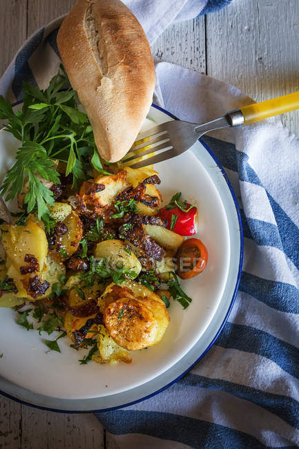 From above fried potatoes with parsley and cherry tomato — Stock Photo