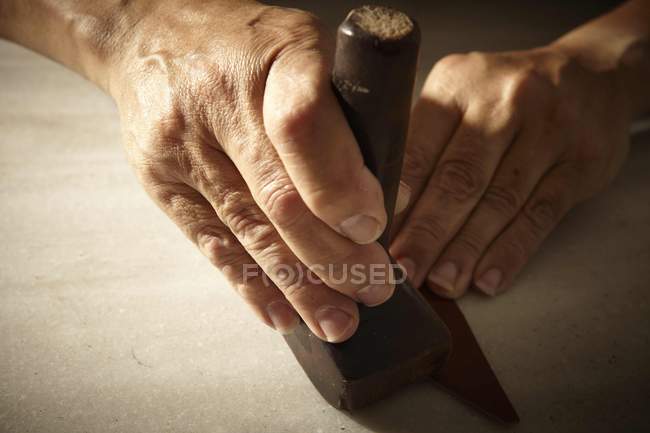 Artisan working with leather and tools — Stock Photo