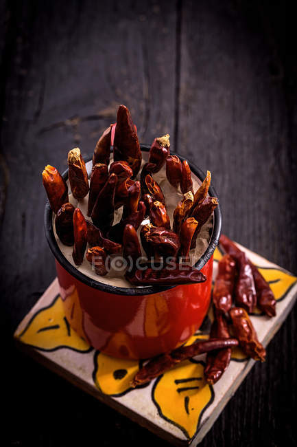 Spicy red chili peppers in cup — Stock Photo
