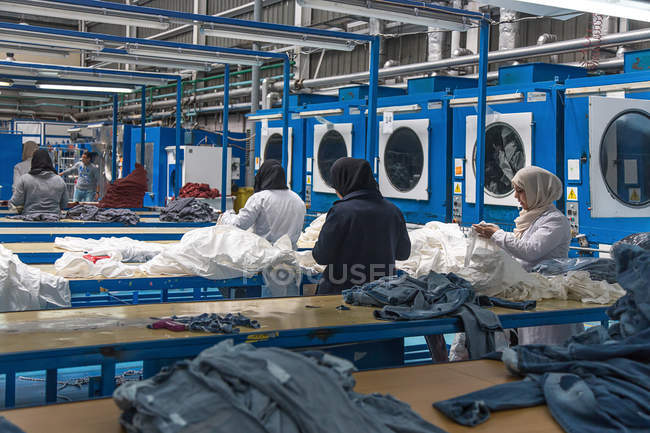 TANGIER, MOROCCO- April 18,2016: rear view of workers at clothing manufactures — Stock Photo