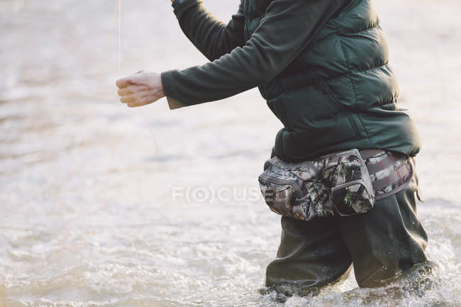 Sezione centrale dell'uomo pescatore in piedi nel fiume — Foto stock