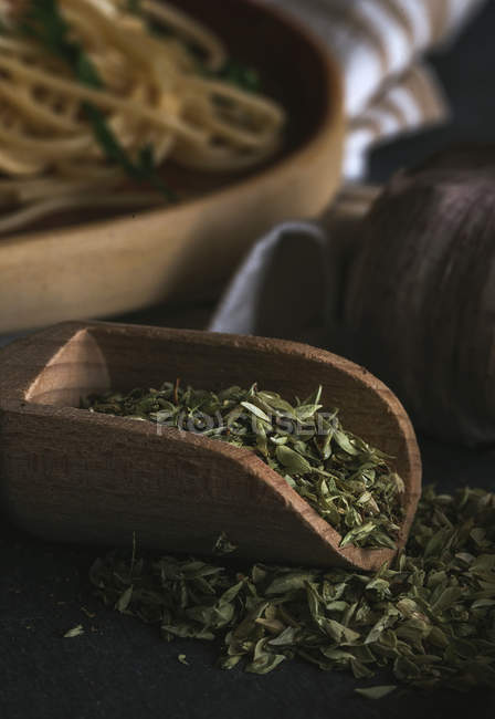 Dried oregano on wooden table — Stock Photo