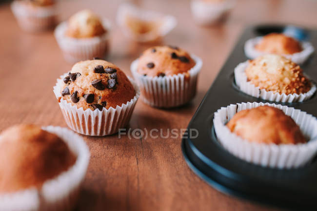 Close up view of homemade muffins with chocolate on table — Stock Photo