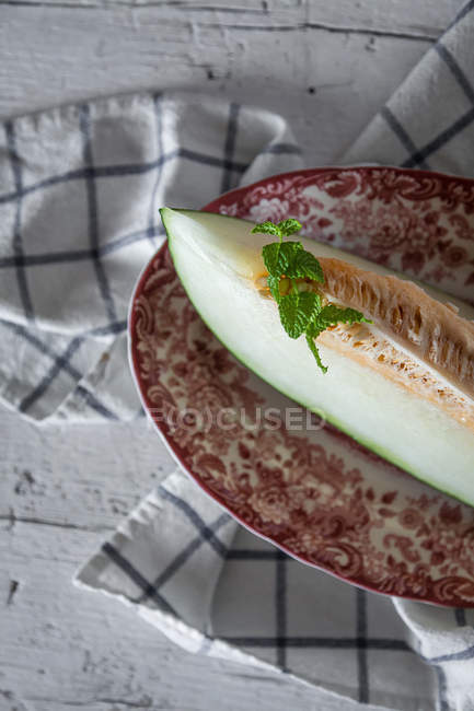 Delicious melon slice on rural table — Stock Photo