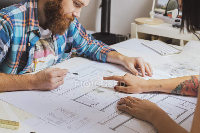 Mid section portrait of designers sitting and working on project sketch — Stock Photo