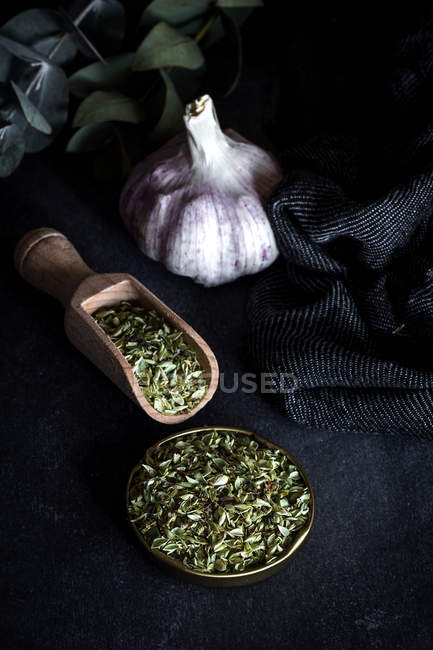 Dried oregano on wooden table — Stock Photo