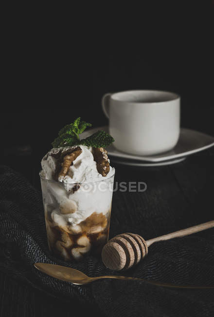 Glass of sundae decorated with nuts — Stock Photo