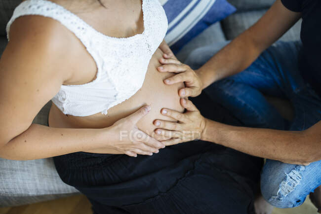 Happy parents embracing their not yet born child, awaiting for moment in mothers tummy. — Stock Photo