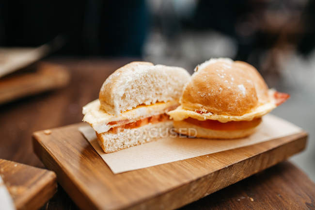 Close up view of sliced burger on wooden board — Stock Photo