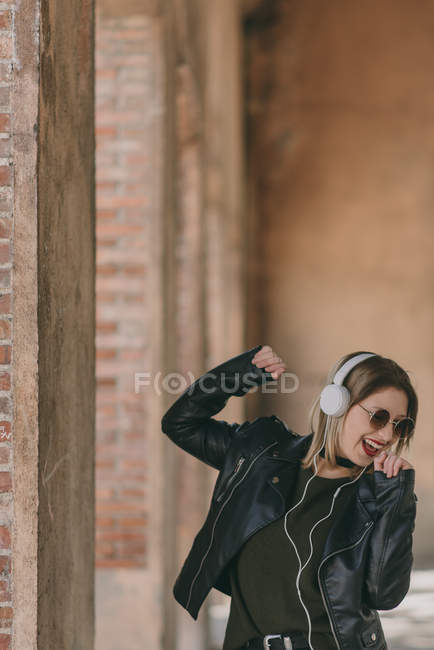 Girl dancing in headphones — Stock Photo