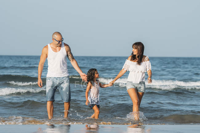 Retrato de familia feliz en la playa a la luz del sol
. - foto de stock