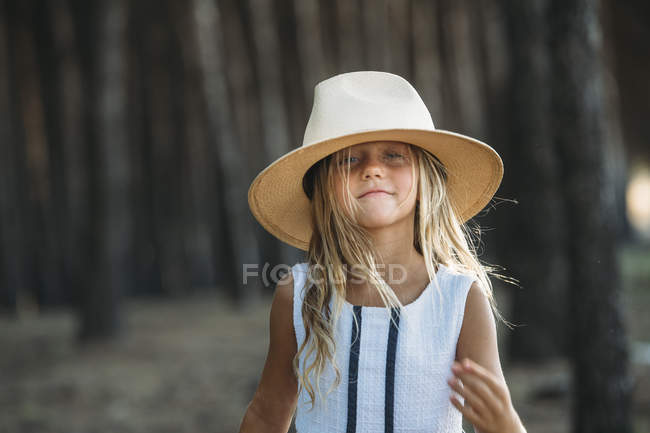 Smiling kid in hat at evening woods — Stock Photo