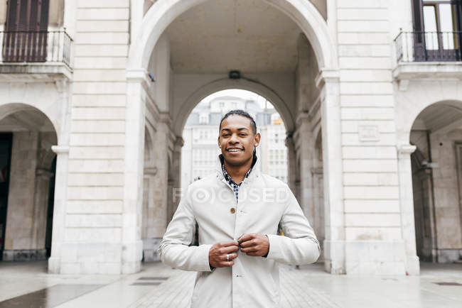 Man posing in stylish outfit and smiling at camera — Stock Photo