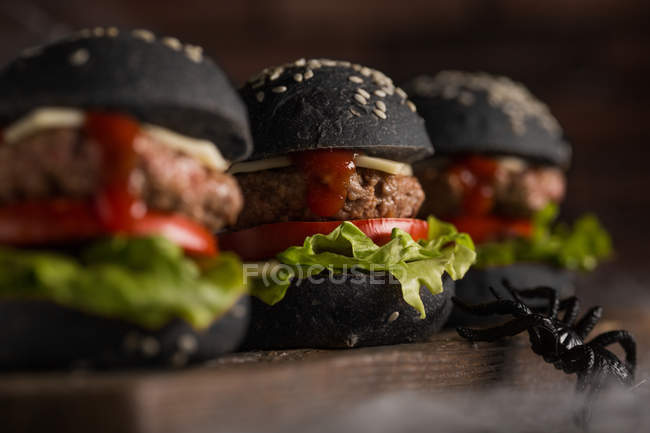 Halloween burgers on wooden board — Stock Photo