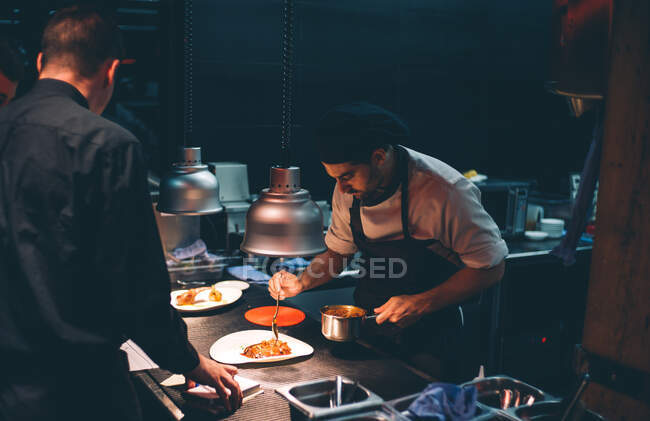 Chef decorating special dishes. — Stock Photo