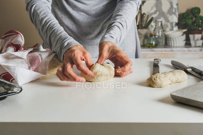 Female hands forming daugh balls — Stock Photo