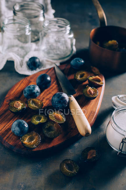 Chopped plums on wooden board — Stock Photo
