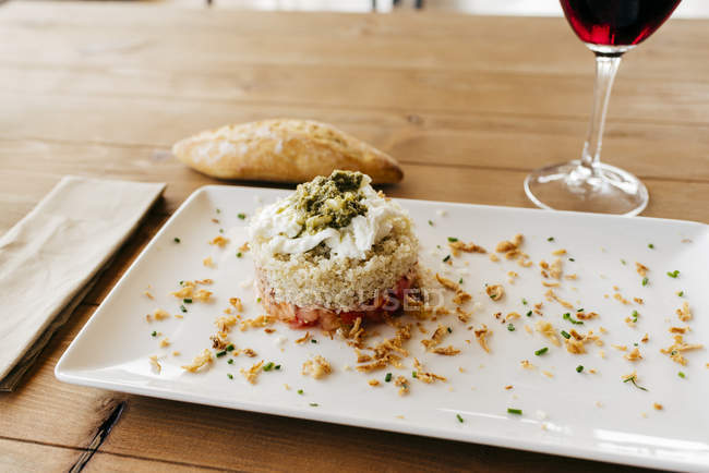 Quinoa dish served with red wine — Stock Photo