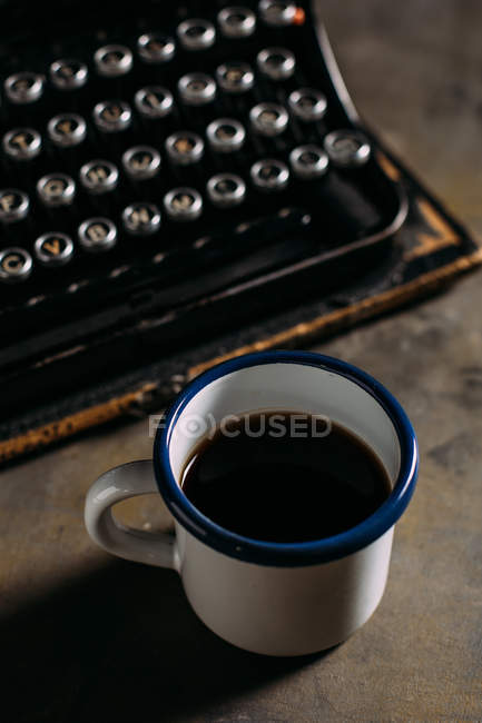 Cup with coffee and typewriter — Stock Photo