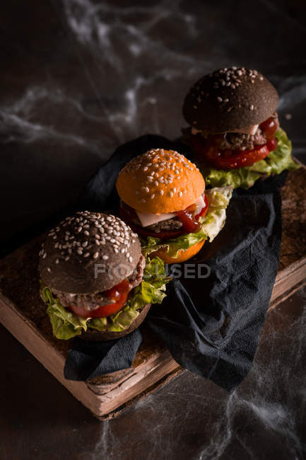 Reihe von Halloween-Burgern auf Holzbrettern — Stockfoto