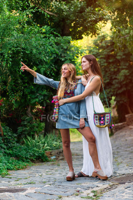 Two girls embracing at street — Stock Photo