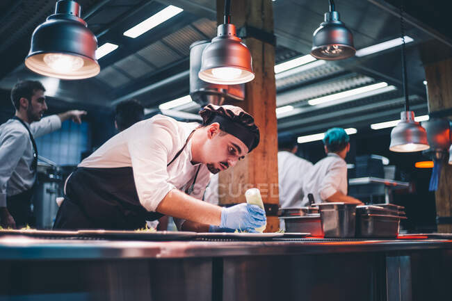 Chef decorating special dishes. — Stock Photo