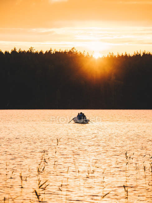 Boat on lake at sunset — Stock Photo