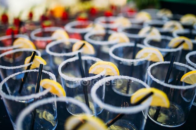 Reihe leerer Gläser mit Zitronenscheiben — Stockfoto