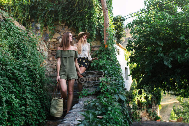 Girls walking downstairs in town — Stock Photo
