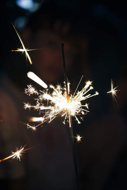 Lighting sparkler at night — Stock Photo