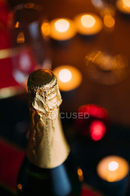 Bouteille de champagne aux bougies — Photo de stock