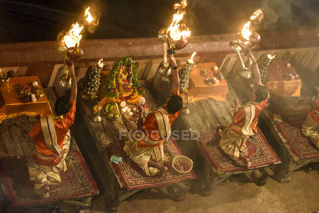 From above traditional Buddhism monks praying with fire in temple. — Stock Photo