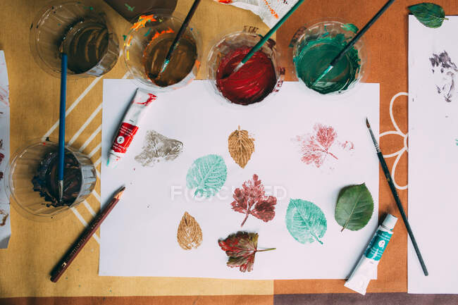 Painted leaves in paper with acrilic paint — Stock Photo