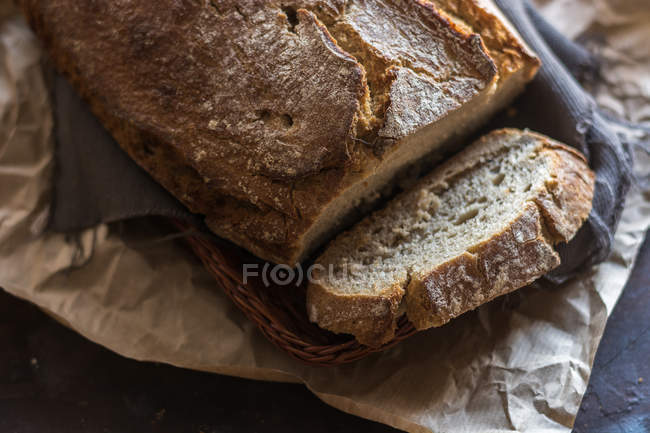 Close up view of  sliced bread loaf on rustic wooden board — Stock Photo
